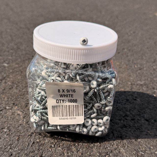 A tub of 9/16 inch track screws with white painted heads